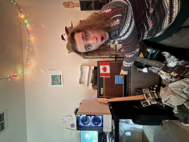 Tyler in his bedroom studio — VOX amp, guitar, Christmas lights